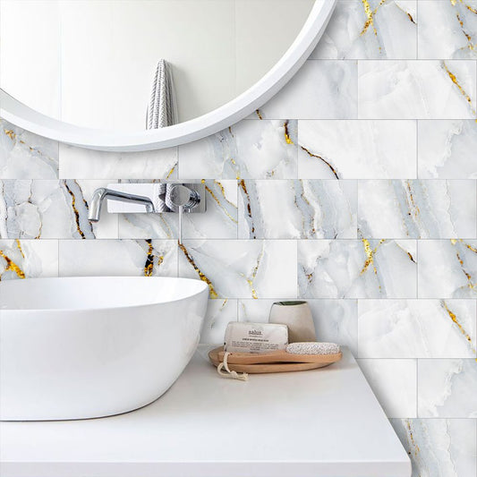 Bathroom with marble-patterned tiles, sink, and circular mirror.
